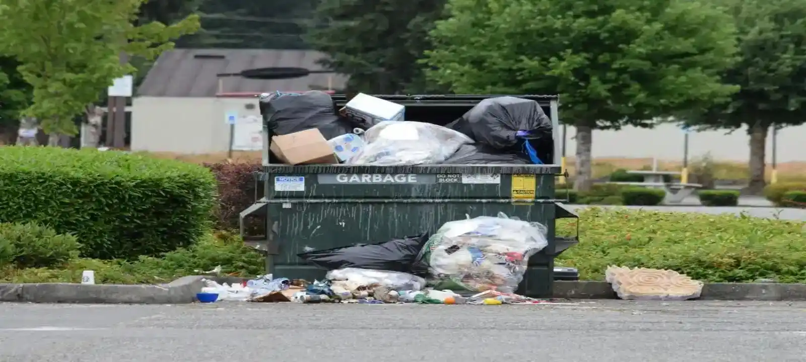 A small skip bin labeled garbage filled to capacity with waste piled up, showing cheapest skip bins townsville service options for proper sized bins
