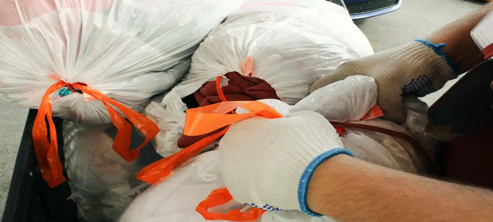 Workers loading and organizing waste into bags as part of cheap skip bin hire townsville service process