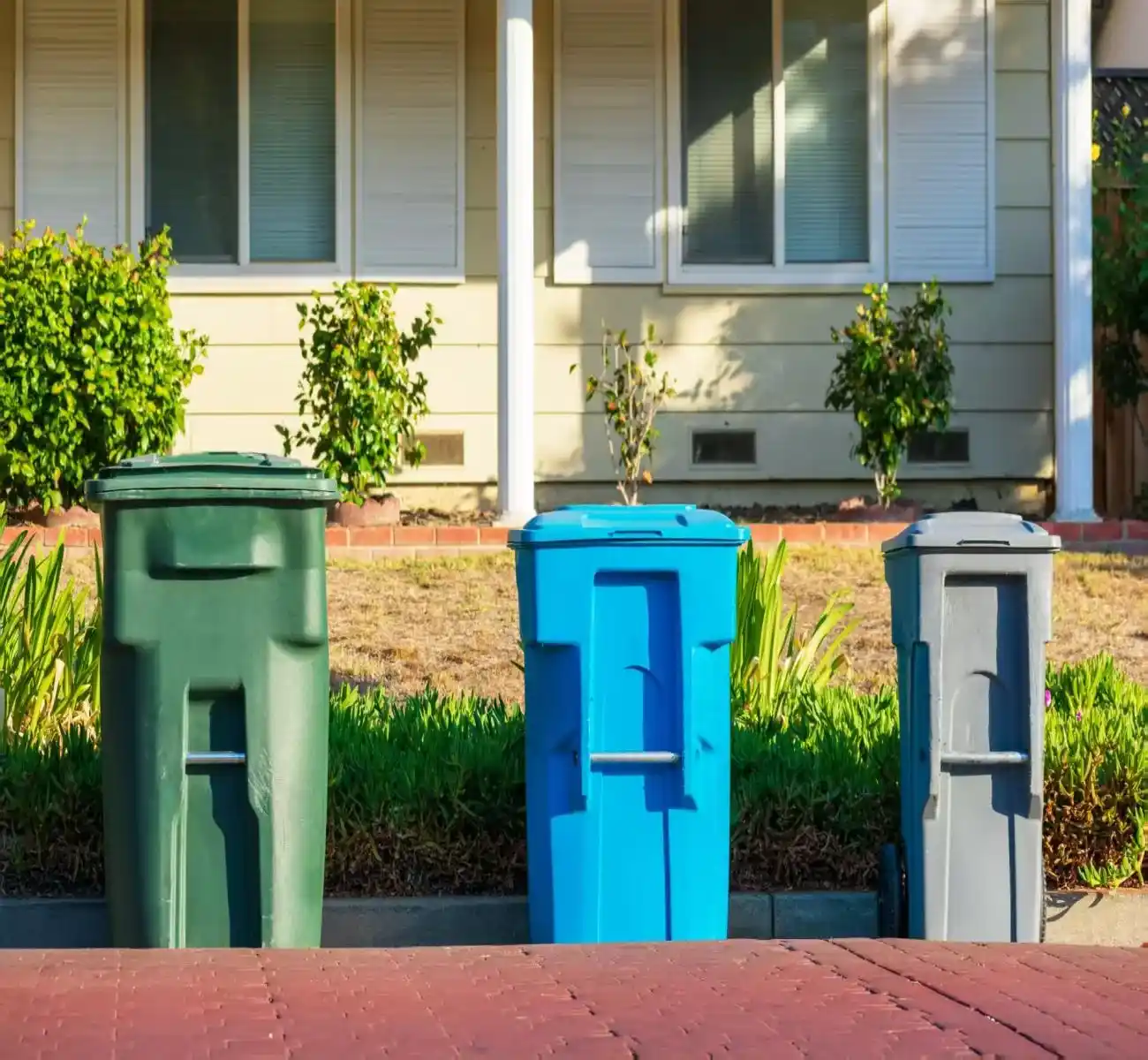 Different sized small skip bins from 2 cubic metre to 4 cubic metre placed beside a residential property for skip bins townsville qld service options