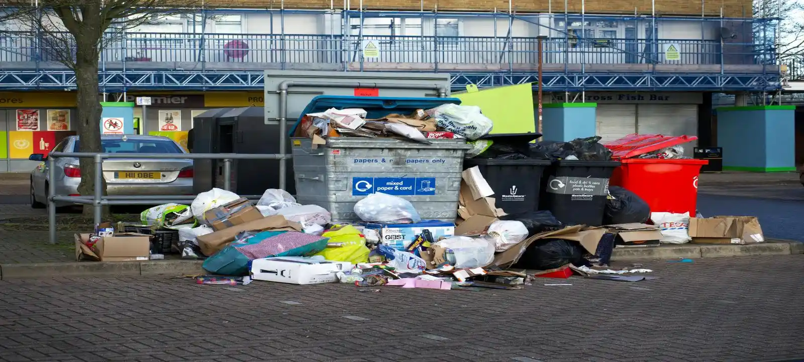 Multiple medium skip bins filled beyond capacity with rubbish overflowing beside them, showing all types of rubbish removal townsville service needs
